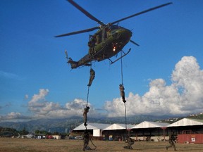 This file photo shows a helicopter from 427 Special Operations Aviation Squadron transporting Jamaican special forces during exercises in Jamaica. CANSOFCOM photo.