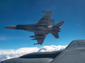 A Royal Canadian Air Force CF-18 Hornet breaks away after refueling with a KC-135 Stratotanker assigned to the 340th Expeditionary Air Refueling Squadron, Thursday,  Oct. 30, 2014 over Iraq.