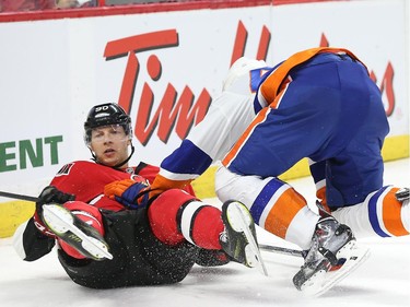 Alex Chiasson, left, of the Ottawa Senators is hit by Calvin de Haan of the New York Islanders during third period action.