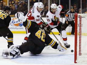 Ottawa Senators' Alex Chiasson (90) and Mika Zibanejad (93) chase a loose puck behind Boston Bruins goalie Tuukka Rask during the first period of an NHL hockey game in Boston, Saturday, Dec. 13, 2014.