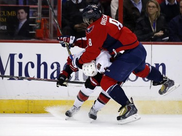 Washington Capitals left wing Alex Ovechkin (8), from Russia, and Ottawa Senators center Jean-Gabriel Pageau (44) collide as they go for the puck in the first period.