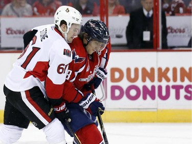 Washington Capitals left wing Alex Ovechkin (8), of Russia, and Ottawa Senators right wing Mark Stone (61) go for the puck in the first period.