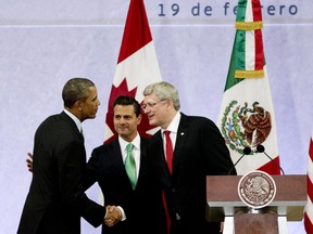 President Barack Obama, left, Mexico's President Enrique Pena Nieto, center, and the Prime Minister of Canada, Stephen Harper, shake hands at the end of a news conference concluding the North American Leaders Summit in Toluca, Mexico, Wednesday, Feb. 19, 2014. The leaders met in part to highlight the economic cooperation that has grown since NAFTA joined the U.S., Canada and Mexico 20 years ago.