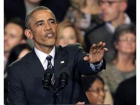President Barack Obama tries to quiet one of three hecklers as he addresses the crowd after meeting with community leaders about the executive actions he is taking to fix the immigration system Tuesday, Nov. 25, 2014, in Chicago.