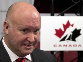 Canadian National Junior hockey team head coach Benoit Groulx speaks to the media at a news conference to announce the roster for Team Canada's junior hockey selection camp in Montreal on Monday, December 1, 2014. The World Junior championships will be held in Toronto and Montreal.