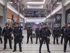 Police move thousands of protesters from the group "Black Lives Matter" out of the mall after they disrupted holiday shoppers on December 20, 2014 at Mall of America in Bloomington, Minnesota.