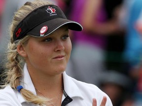 Brooke Henderson of Canada responds to the crowd on the 14th hole, during final round play at the Canadian Pacific Women's Open golf tournament in London, Ont., on Sunday, Aug. 24, 2014.