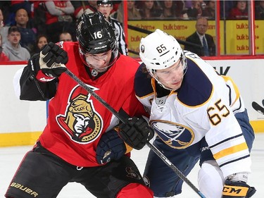 Clarke MacArthur #16 of the Ottawa Senators battles for position against Brian Flynn #65 of the Buffalo Sabres in the first period.