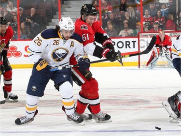 Mark Stone #61 of the Ottawa Senators battles for position against Matt Moulson #26 of the Buffalo Sabres in the first period.