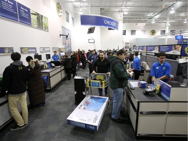 Cashiers process Boxing Day purchases at Best Buy on Merivale Road.