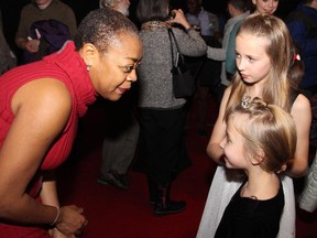 Cast member Karen Robinson (Red Queen) mingles with Isabelle Lacelle and her younger sister Sarah at the opening night of Alice Through the Looking Glass at the National Arts Centre on Friday, December 12, 2014.