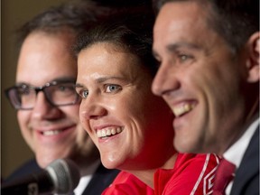 Canadian national women's team captain Christine Sinclair laughs with coach John Herdman and Organizing committee member Victor Montagliani during a FIFA news conference Friday in Ottawa.