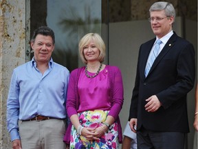 Colombian President Juan Manuel Santos (L) and wife Maria Clemencia Rodriguez (R) pose with Canadian Prime Minister Stephen Harper (2-R) and his wife Laureen (2-L) upon their arrival at the Julio Cesar Turbay Ayala Convention Center for 2012 Summit of the Americas August 14, 2012 in Cartagena, Colombia.