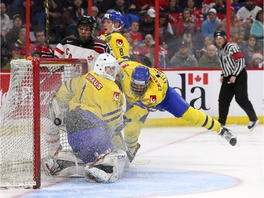 Connor McDavid #17 of Team Canada watches the puck get past Samuel Ward #1 and Oliver Kylington #4 of Team Sweden in the third period during an World Junior Hockey pre-tournament game at Canadian Tire Centre in Ottawa on December 21, 2014.