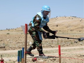 A Cambodian mine expert demonstrates his work on April 23, 2014, in the UN-controlled buffer zone in Cyprus.