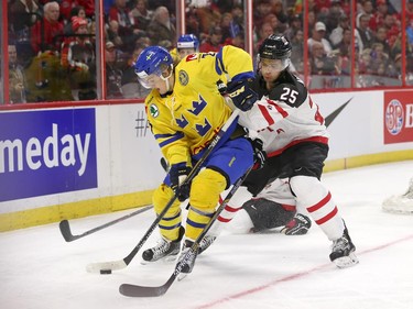 Darnell Nurse of Team Canada defends against William Nylander of Team Sweden in the second period at the Canadian Tire Centre on Sunday, Dec. 21, 2014.