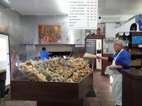 Daytrips story on Montreal shops that Making bagels in a wood-burning oven is hot work at St. Viateur Bagel.