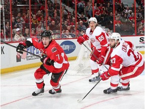 Kyle Turris skates for the corner against Kyle Quincey and Danny DeKeyser of the Detroit Red Wings Saturday night. The game featured an unusual burst of three-on-three play.