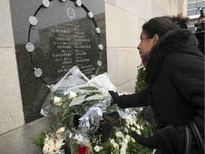 Dominique Anglade paces flowers at the memorial plaque to mark the 25th anniversary of the Polytechnique massacre Saturday, December 6, 2014 in Montreal.