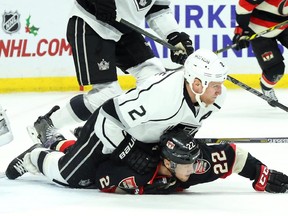 Erik Condra of the Ottawa Senators is tackled by Matt Greene of the LA Kings during first period NHL action.