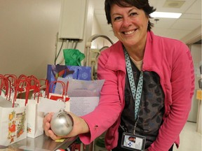 Every year the neonatal intensive care unit at The Ottawa Hospital receives gifts from generous donors. Nurse Charlene Shanks holds one of the Christmas balls staff nurses made for the babies.