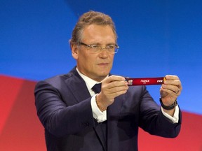 FIFA Secretary-General Jerome Valcke displays tag with the name France during a ceremony in Gatineau, Que., Saturday, December 6, 2014 during a FIFA draw for team groupings that will competing at the Canada 2015 FIFA Women's World Cup Football. Players challenging the use of artificial turf at next year's Women's World Cup have offered to meet Valcke in Brazil to discuss their differences.