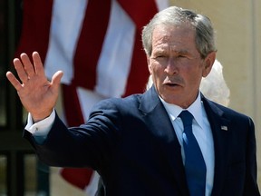 Former President George W. Bush waves goodbye after attending the opening ceremony of the George W. Bush Presidential Center April 25, 2013 in Dallas, Texas.