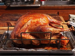 An improved set-up for roasting turkey involves putting the bird on a roasting rack above a baking tray- and then putting a pizza stone or baking steel below.  Photo credit: J. Kenji Lopez-Alt, author of The Food Lab and Managing Culinary Director of Serious Eats