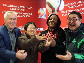From left, Even Pellerud, head coach of Norway's women's soccer team; Thailand's coach, Nuengrutai Srathongvian;  Ivory Coast's coach,  Clementine Toure, and team manager for Mexico's women's national soccer team, Gerardo Lepe, toss a soccer ball in the air at a press availability session the R.A. Centre in Ottawa.