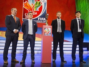 From left, Group A coaches, Roger Reijners for Netherlands, John Herdman for Canada, Tony Readings for New Zealand and Hao Wei for China PR pose with the Women's World Cup trophy during  FIFA Women's World Cup Canada 2015™ Official Draw at the Canadian Museum of History in Gatineau, QC Saturday December 6, 2014. Canada will play China PR in the opening match.