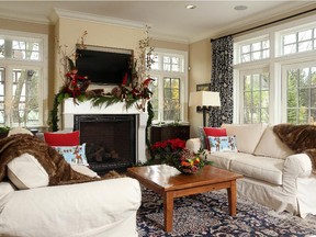 Arrangements with round Coulter and long silver pine cones, birch, boxwood and cedar dress up the family room.