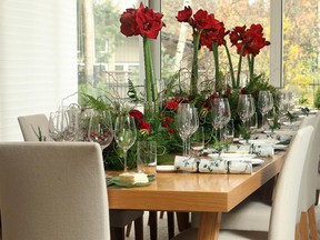 As one of the official colours of New Zealand, red amaryllis blooms add a burst of colour to the minimalist decor. The dining room centrepiece also includes Christmas crackers, sliced kiwi fruit, curly willow, spray roses, ferns and Hypericum berries.