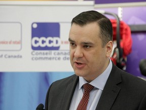 Industry Minister James Moore announces legislation aimed at ensuring prices in Canada are not unfairly higher than those in the U.S., in Toronto, on Tuesday December 9, 2014.