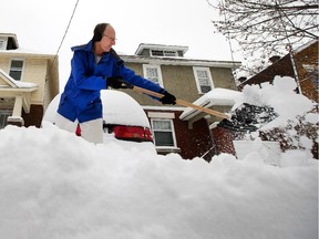 Jim Elder shovels snow in front of home on Smirle Avenue on Thursday after the overnight snowstorm.
