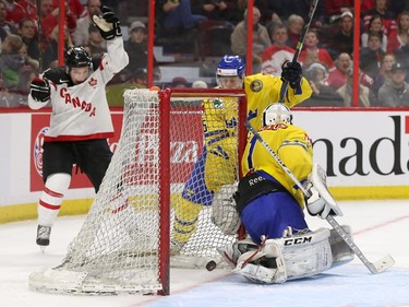 Joe Hicketts #2 of Team Canada celebrates a third period goal against Samuel Ward #1 of Team Sweden as Robin Norel #5 of Team Sweden looks on in the third period during an World Junior Hockey pre-tournament game at Canadian Tire Centre in Ottawa on December 21, 2014.