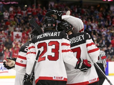 Joe Hicketts #2, Sam Reinhart and Josh Morrisey of Team Canada celebrate a third period goal against Team Sweden during an World Junior Hockey pre-tournament game at Canadian Tire Centre in Ottawa on December 21, 2014.