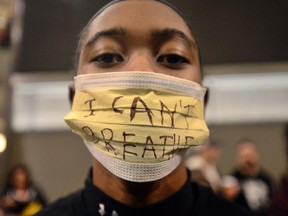 KanKemwa Green of Mankato, Minn participates in a protest at the Mall of America Saturday, Dec. 20, 2014, in Bloomington, Minn. The group Black Lives Matter Minneapolis had more than 3,000 people confirm on Facebook that they would attend.