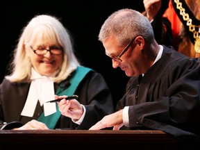 Keith Egli is sworn in as Councillor for Ward 9 Knoxdale-Merivale by Justice Louise Logue  at Centrepointe Theatre and witnessed by Ottawa Mayor Jim Watson, December 01, 2014.  (Jean Levac/ Ottawa Citizen) ORG XMIT: 1202 newcouncil
