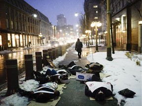 Local high school students lay on the sidewalk in front of the U.S. Embassy as they participate in Die-in rally to protest allegations of police racism and violence in United States on Wednesday.