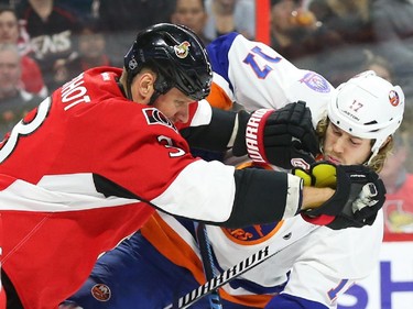 Marc Methot, left, of the Ottawa Senators hits Matt Martin of the New York Islanders during second period action.