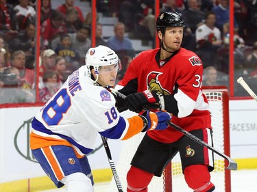 Marc Methot, right, of the Ottawa Senators battles against Ryan Strome of the New York Islanders during second period action.
