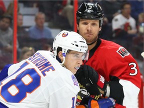 Marc Methot (R) of the Ottawa Senators battles against Ryan Strome of the New York Islanders during second period action at the Canadian Tire Centre in Ottawa, December 04, 2014. (Jean Levac/ Ottawa Citizen)