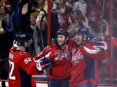 Washington Capitals defenseman Mike Green (52), center Brooks Laich (21) and center Jay Beagle, right, celebrate Beagle's goal in the second period.