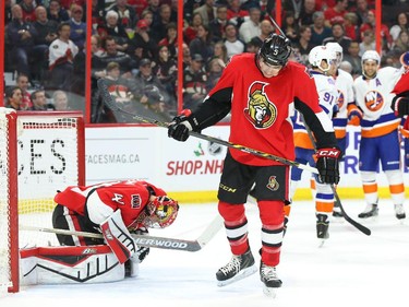 Craig Anderson (41) and Cody Ceci (5) of the Ottawa Senators react after the New York Islanders scored during second period action.