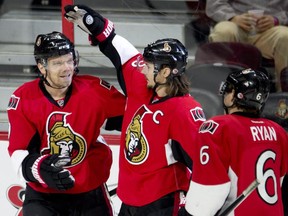 Ottawa Senators defenseman Erik Karlsson, centre, and Bobby Ryan congratulate teammate Milan Michalek on his first period goal against Anaheim Ducks goalie Ilya Bryzgalov.