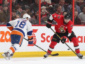 Chris Phillips #4 of the Ottawa Senators makes a pass against Ryan Strome #18 of the New York Islanders in the second period.