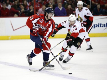 Washington Capitals center Nicklas Backstrom (19), from Sweden, skates with the puck as Ottawa Senators right wing Erik Condra (22) defends, in the first period.