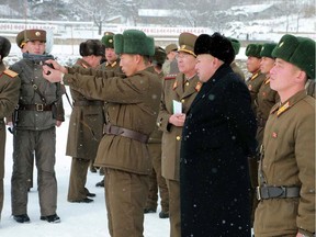This undated picture released from North Korea's official Korean Central News Agency (KCNA) on December 5, 2014 shows North Korean leader Kim Jong-Un (C) inspecting the new year combat and political drill of the Korean People's Army (KPA) unit 1313 at undisclosed place in North Korea.