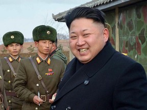This picture taken by North Korea's official Korean Central News Agency (KCNA) on Decemberr 1, 2014 shows North Korean leader Kim Jong-Un (R)  inspecting the artillery company under Korean People's Army (KPA) unit 963 which started the new year combat and political drill at an undisclosed place in North Korea.