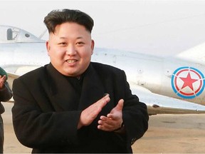 This undated picture released from North Korea's official Korean Central News Agency (KCNA) on November 28, 2014 shows North Korean leader Kim Jong-Un (C) inspecting a flight drill of pursuit airwomen of the KPA Air and Anti-Air Force at an undisclosed location in North Korea.  REPUBLIC OF KOREA OUT